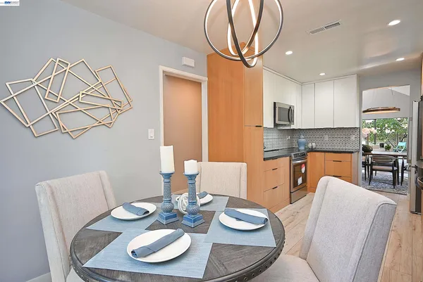 a kitchen with furniture and a dining table