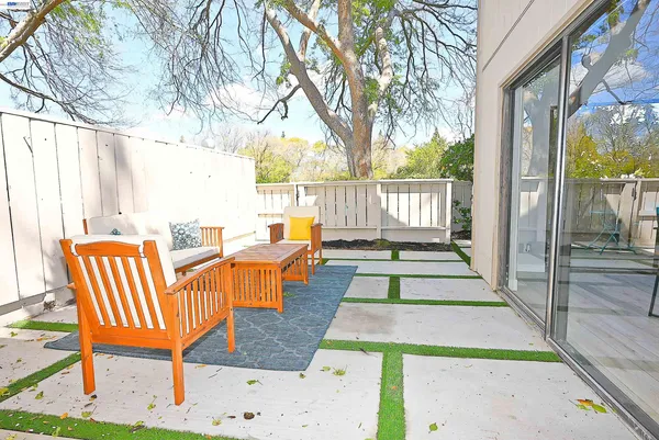 a view of a patio with table and chairs and wooden floor