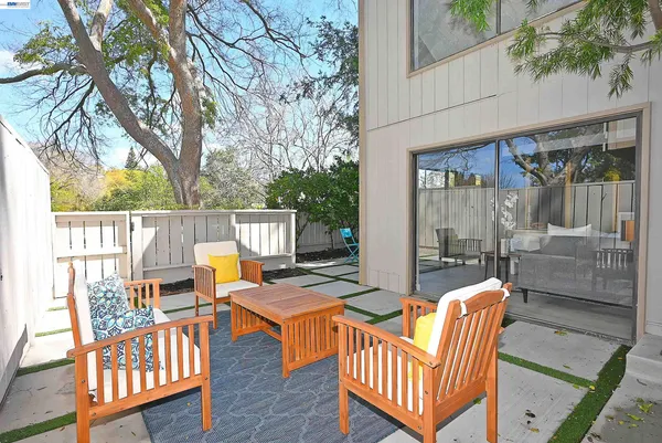 a view of a patio with iron fence
