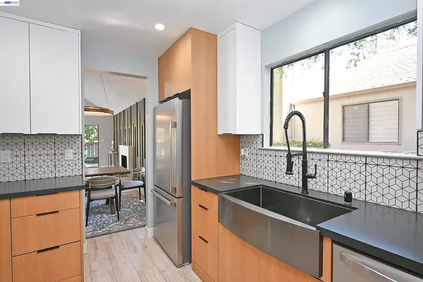 a kitchen with stainless steel appliances a sink a counter space and a window