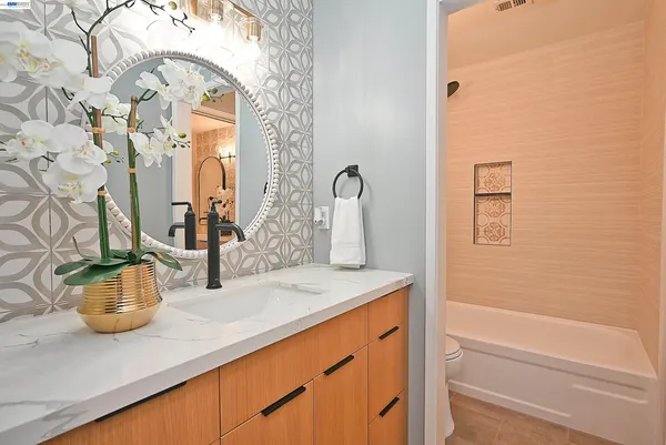 a bathroom with a sink a mirror and a bathtub