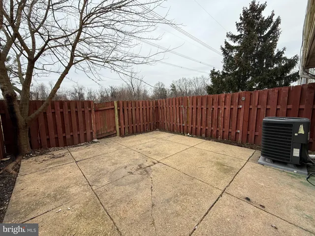 a view of backyard with wooden fence