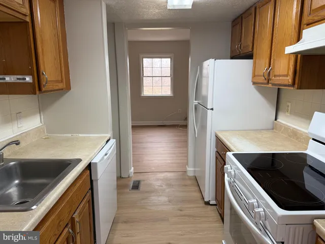 a kitchen with a sink a stove and a microwave