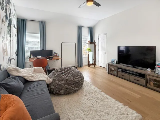 a bedroom with furniture and a flat screen tv