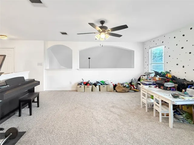 a room with furniture a chandelier and a window