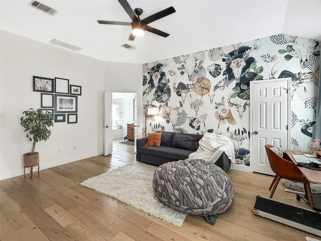 a living room with furniture and a potted plant