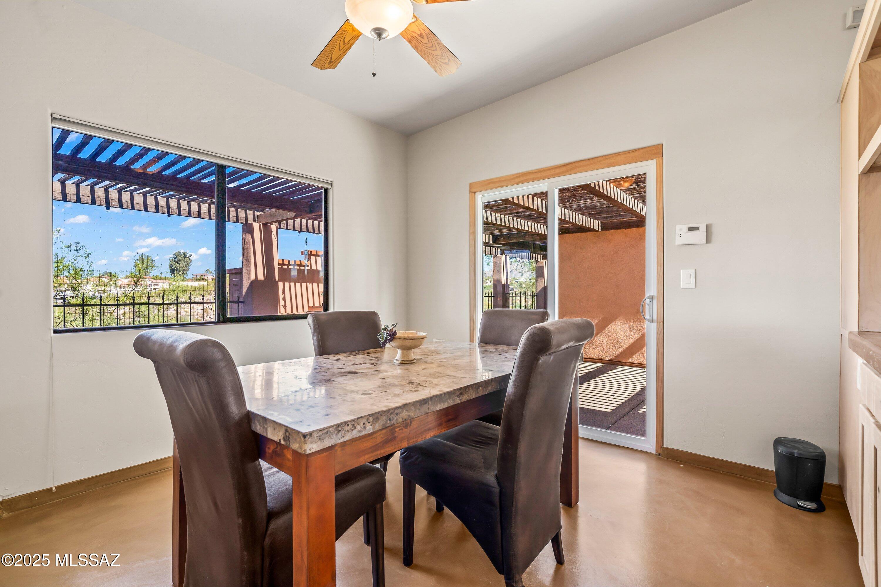 30 West Stone Loop Tucson, AZ 85704 - Photo 18 of 26 a view of a dining room with furniture window and outside view