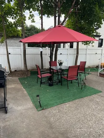 a view of a house with backyard and sitting area