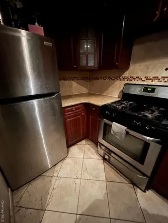 a kitchen with a refrigerator and a sink