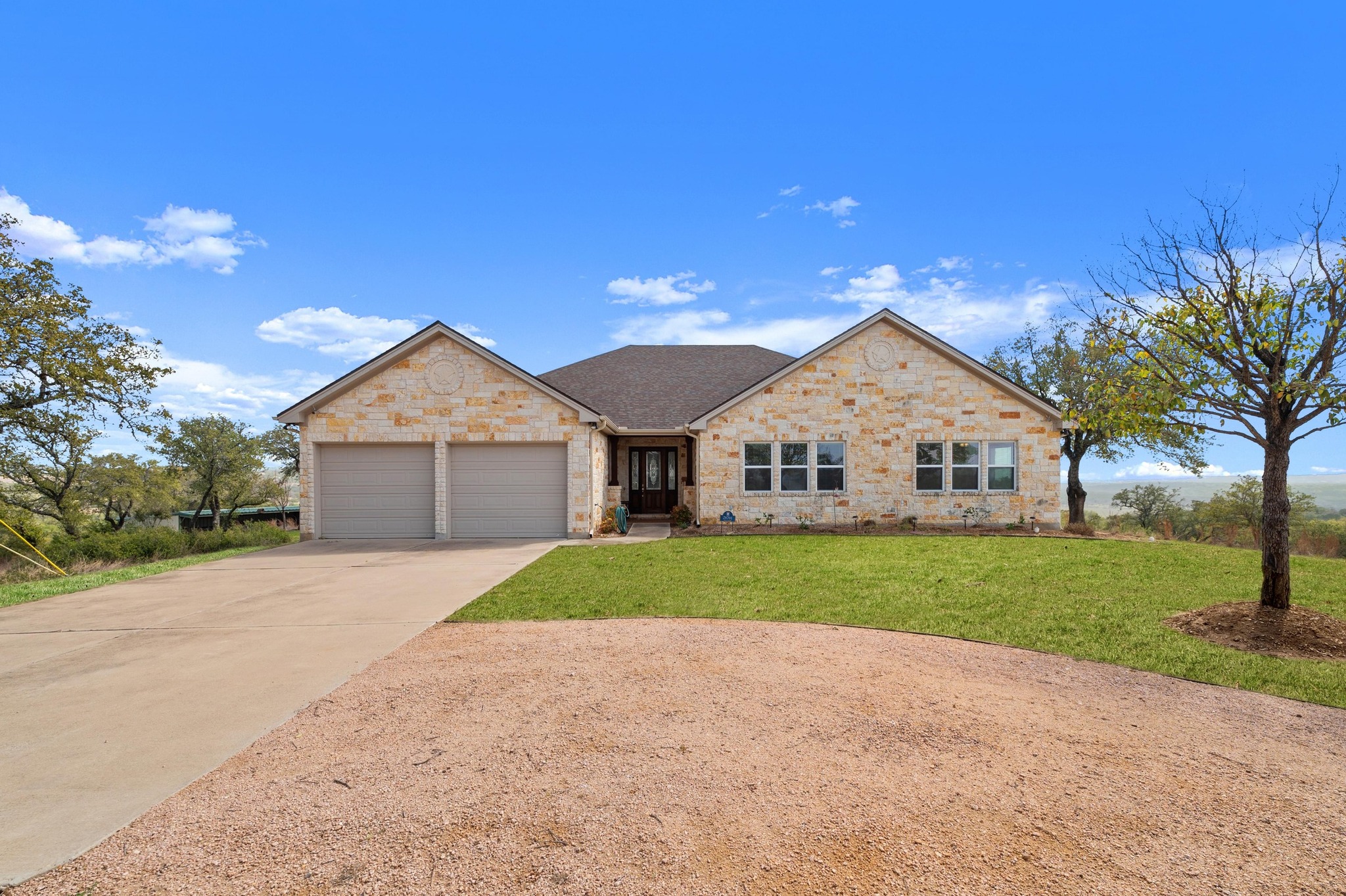 28701 Valley Road Marble Falls, TX 78654 - Photo 5 of 35 a front view of a house with a yard and garage
