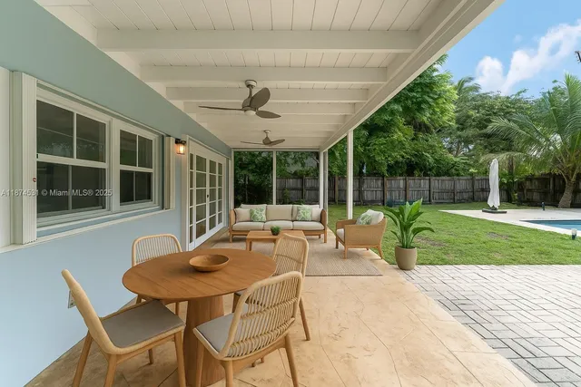 a view of a patio with a table chairs and a backyard