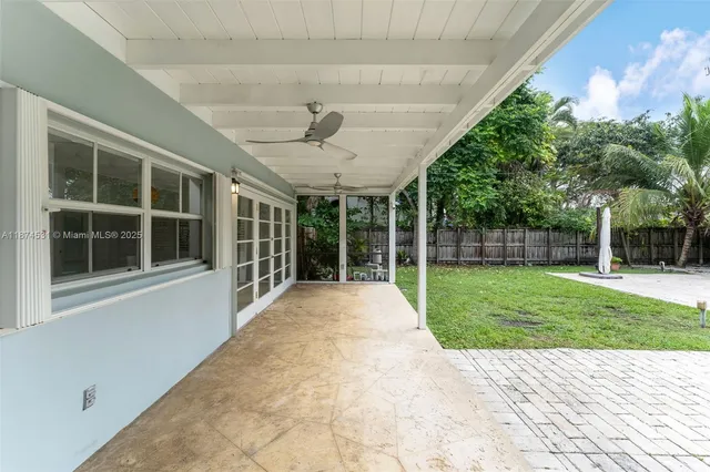 a view of a house with a backyard
