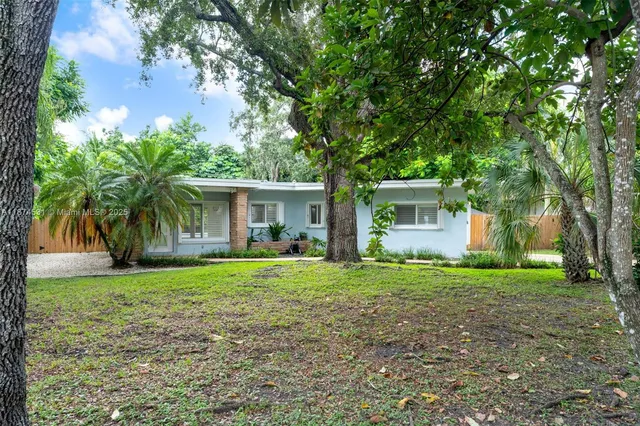 a front view of house with yard and green space