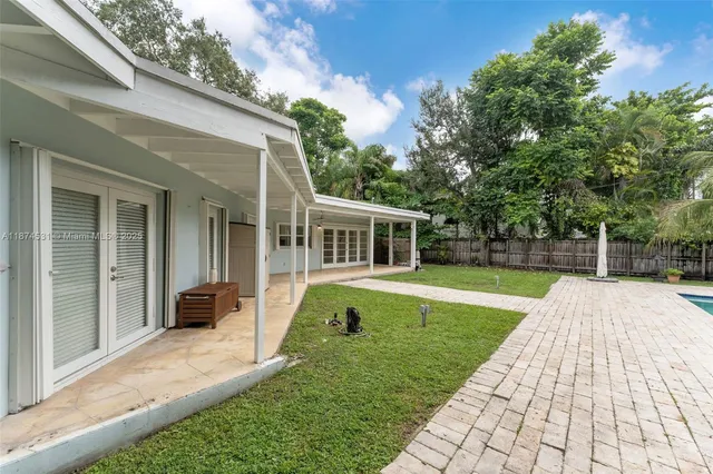 a house view with swimming pool in front of it