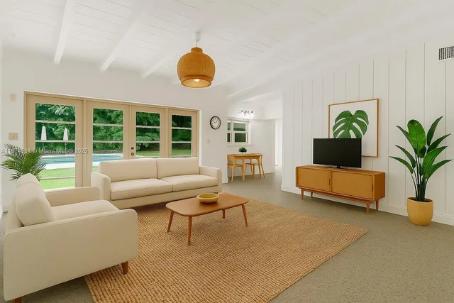 a living room with furniture and a large window