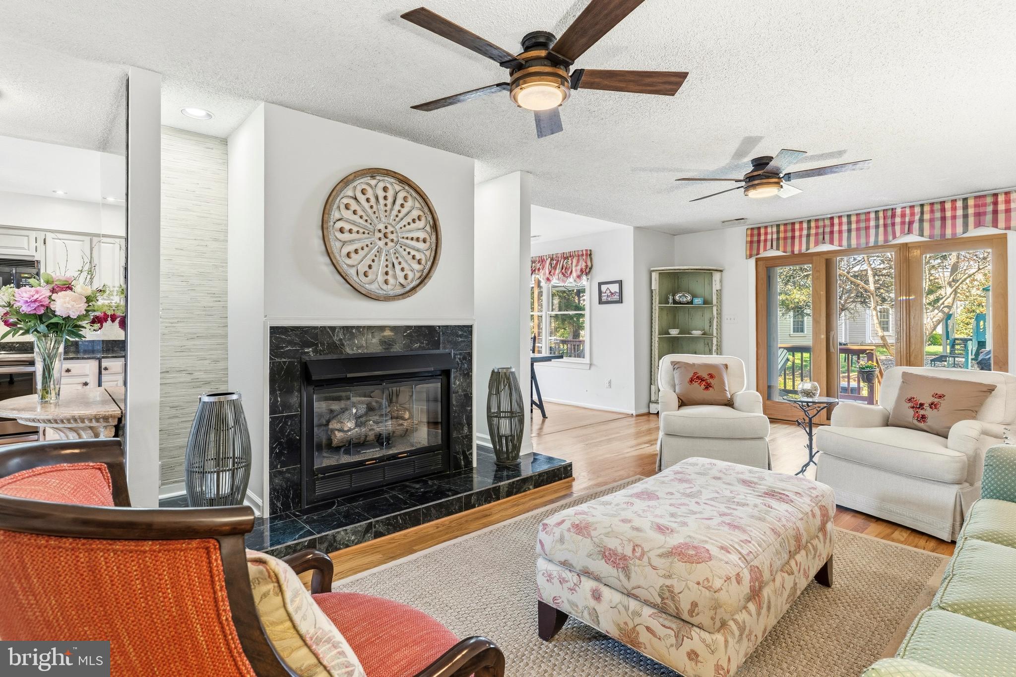 754 Bellefield Road, Unit 103 Solomons, MD 20629 - Photo 11 of 62 a living room with furniture a clock and a fireplace