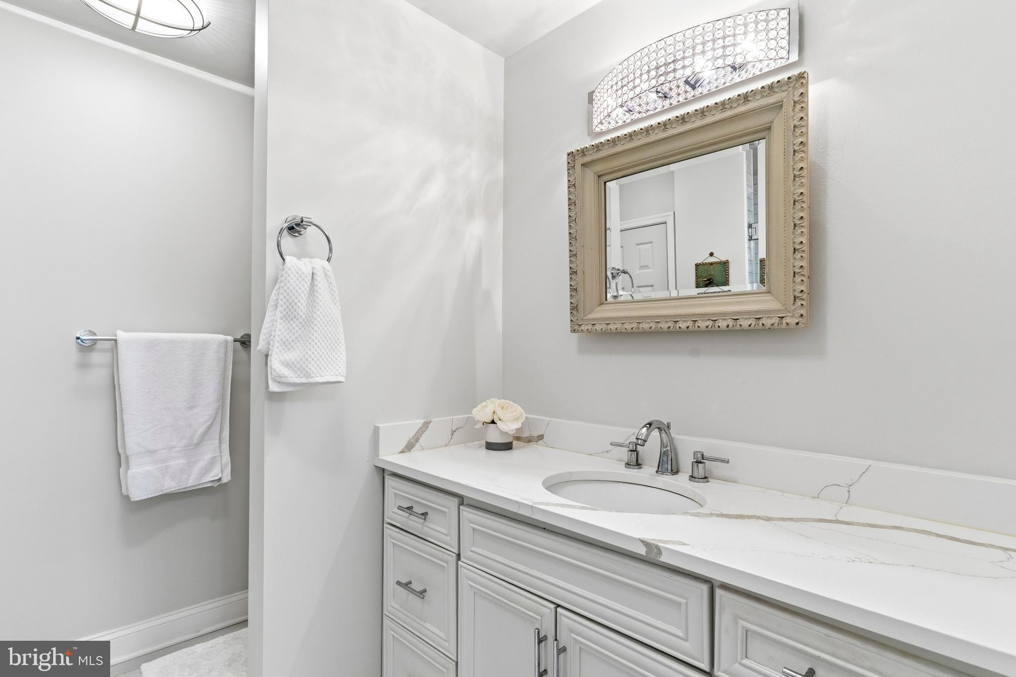 754 Bellefield Road, Unit 103 Solomons, MD 20629 - Photo 21 of 62 a bathroom with a sink vanity and mirror