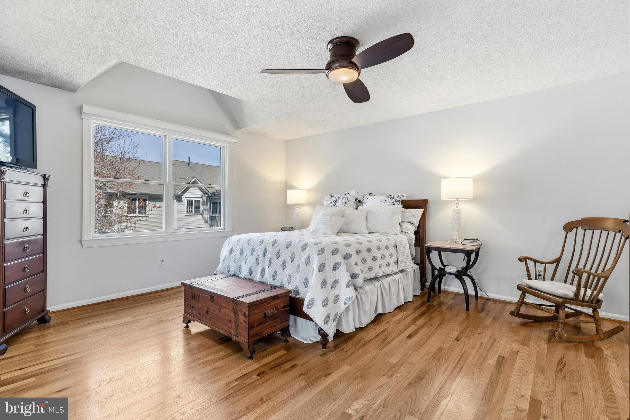 754 Bellefield Road, Unit 103 Solomons, MD 20629 - Photo 25 of 62 a bedroom with a bed and a chair