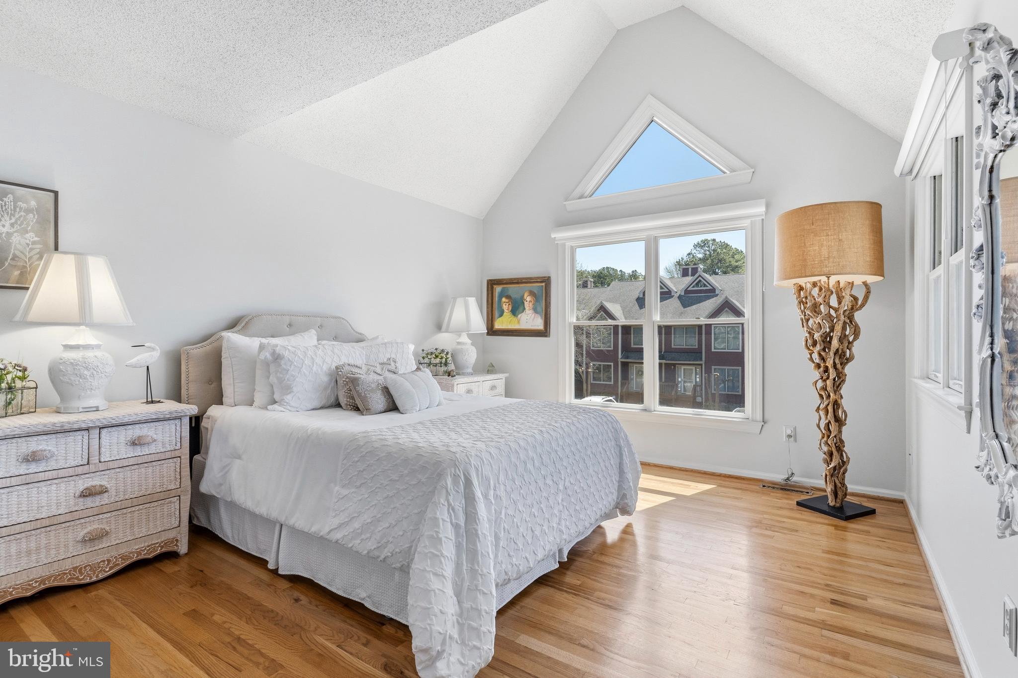 754 Bellefield Road, Unit 103 Solomons, MD 20629 - Photo 30 of 62 a bedroom with a large bed and a large window