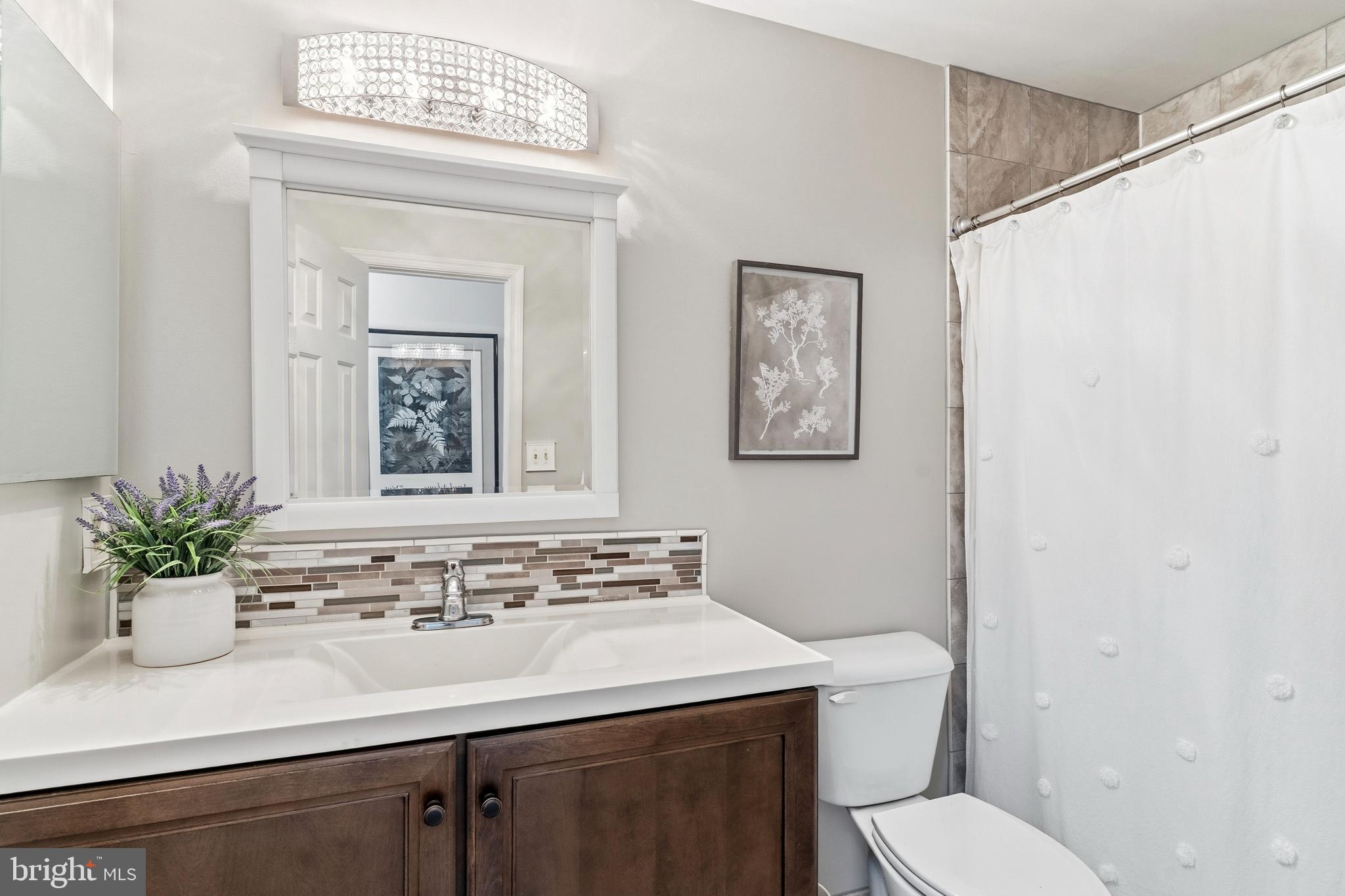 754 Bellefield Road, Unit 103 Solomons, MD 20629 - Photo 32 of 62 a bathroom with a sink a mirror and a toilet