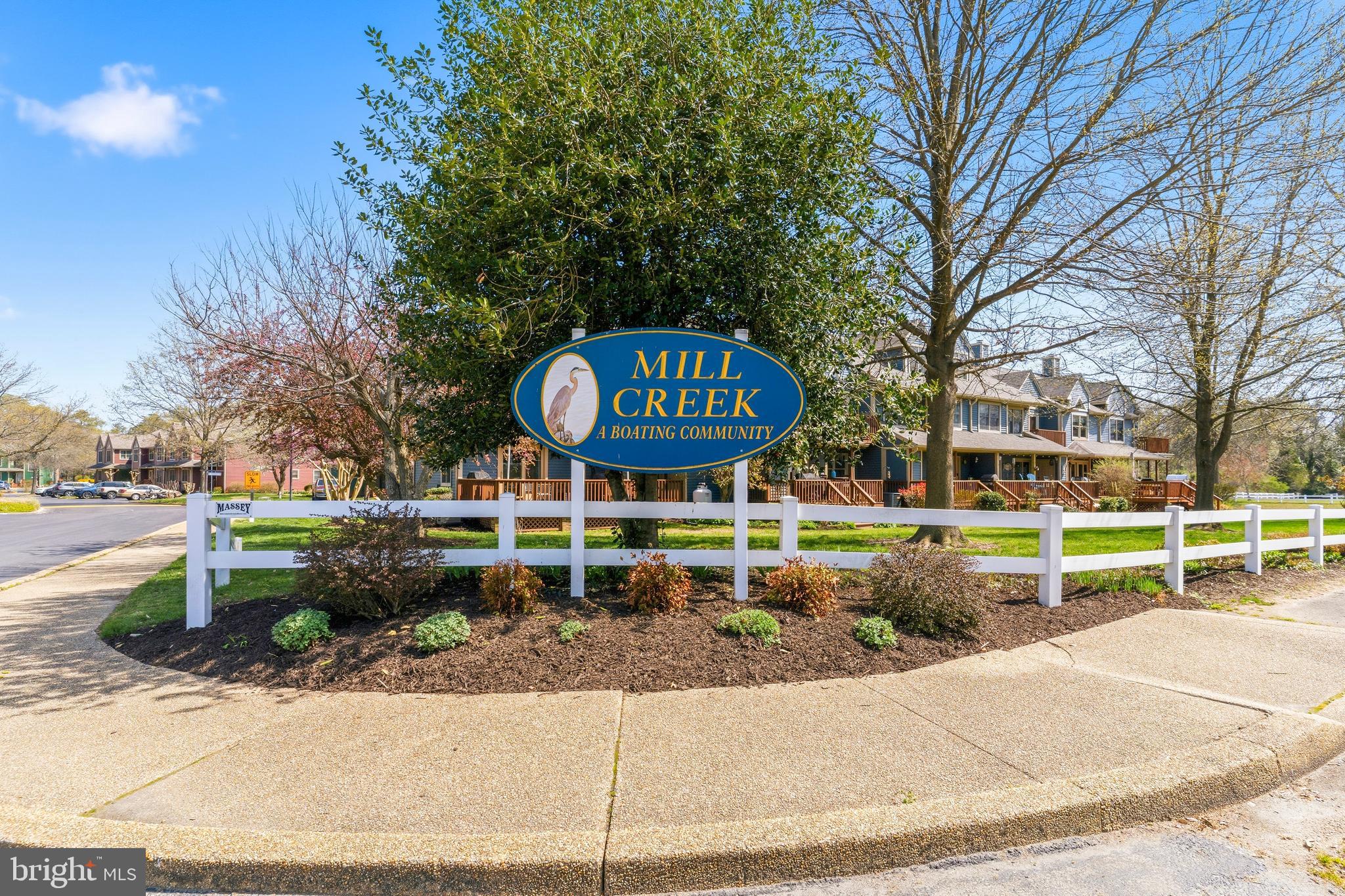 754 Bellefield Road, Unit 103 Solomons, MD 20629 - Photo 36 of 62 a view of a garden with a fountain and potted plants