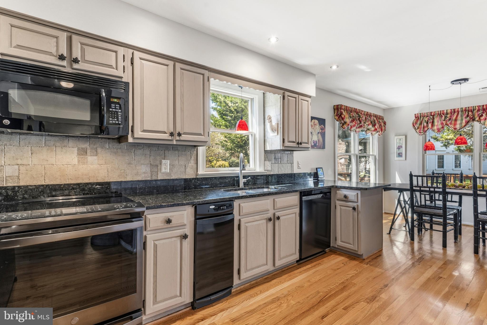 754 Bellefield Road, Unit 103 Solomons, MD 20629 - Photo 6 of 62 a kitchen with stainless steel appliances granite countertop wooden cabinets stove and sink
