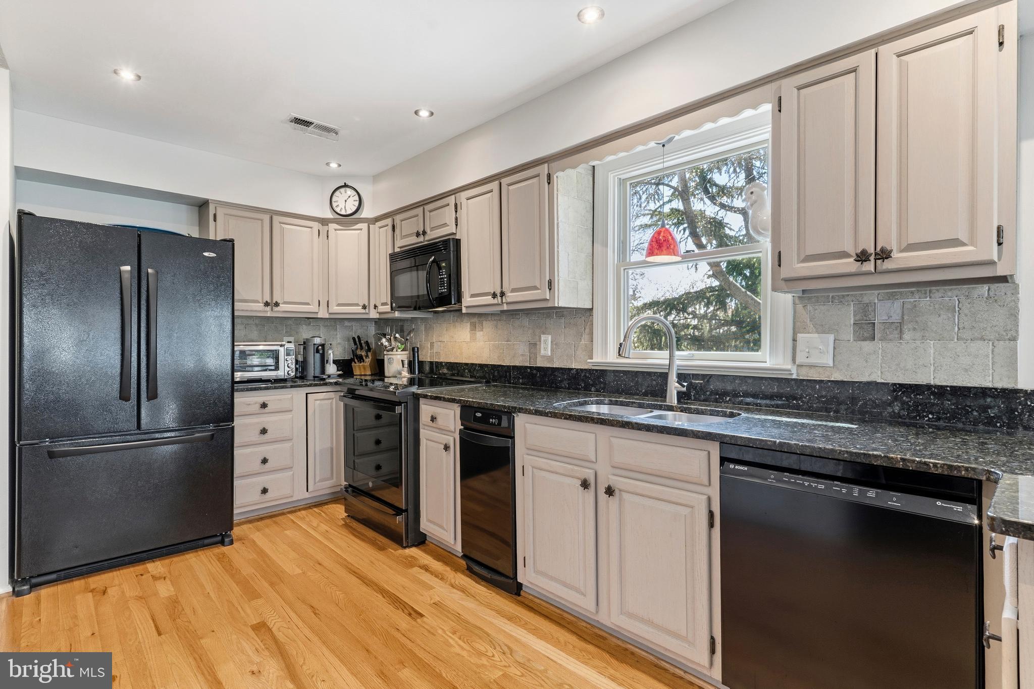 754 Bellefield Road, Unit 103 Solomons, MD 20629 - Photo 7 of 62 a kitchen with stainless steel appliances granite countertop a refrigerator sink and stove