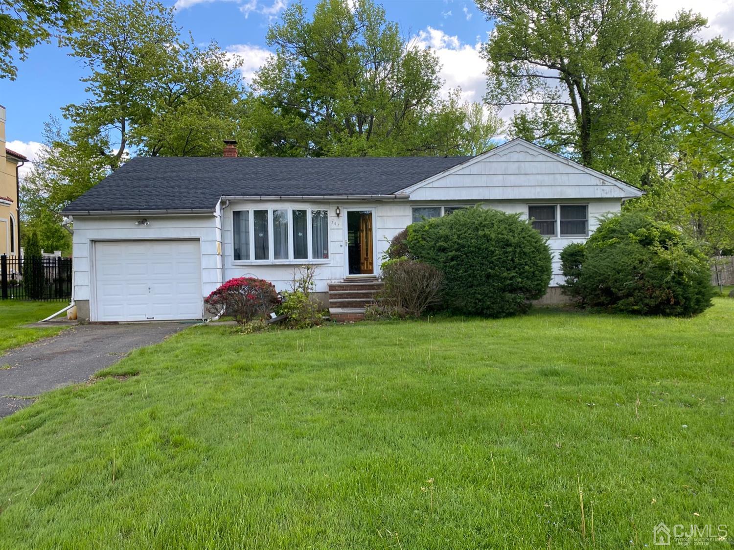747 New Dover Road Edison, NJ 08820 - Photo 1 of 3 a front view of a house with a garden