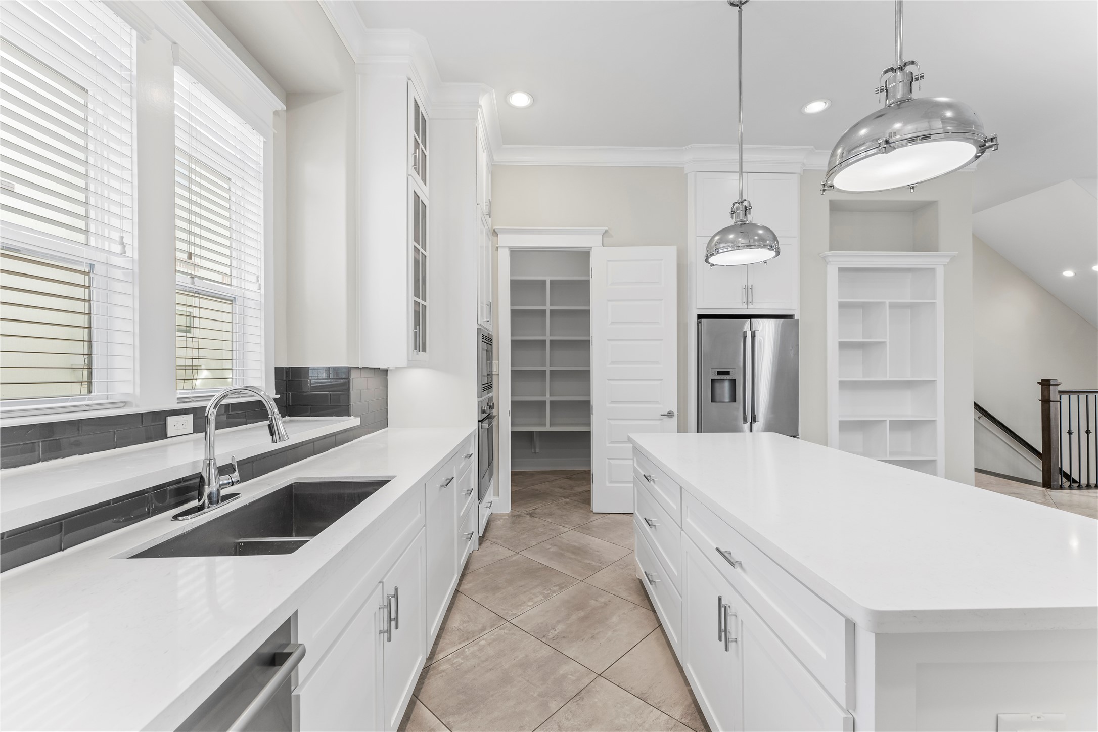 2806 Princeton Street Houston, TX 77009 - Photo 13 of 20 a large white kitchen with a large window a sink and stainless steel appliances