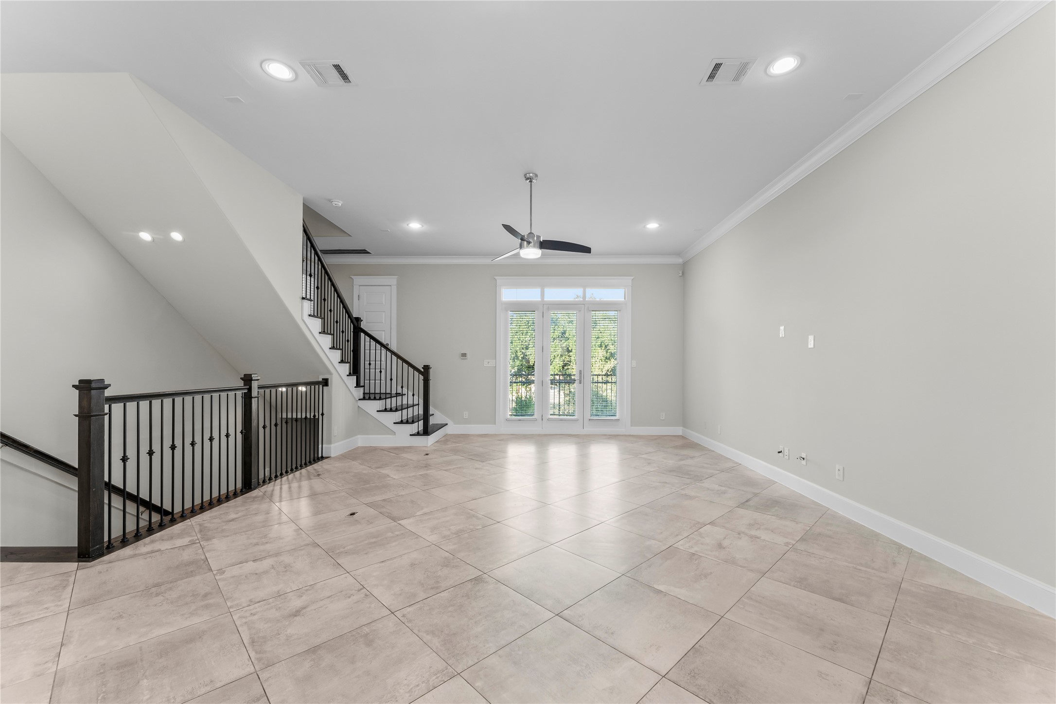 2806 Princeton Street Houston, TX 77009 - Photo 9 of 20 an empty room with windows and stairs