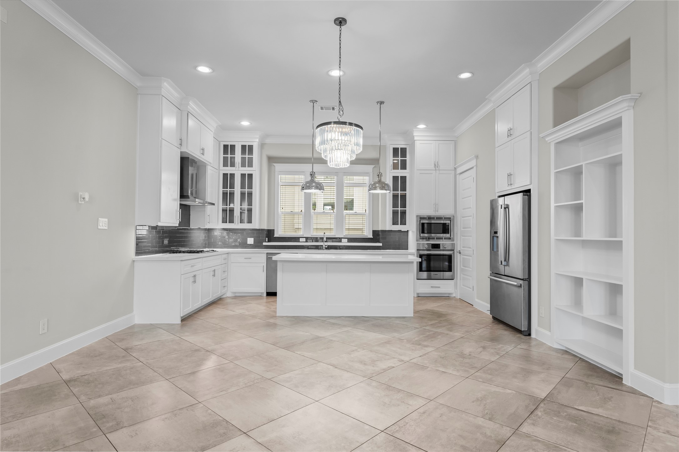 2806 Princeton Street Houston, TX 77009 - Photo 10 of 20 a large white kitchen with a refrigerator a stove and a sink