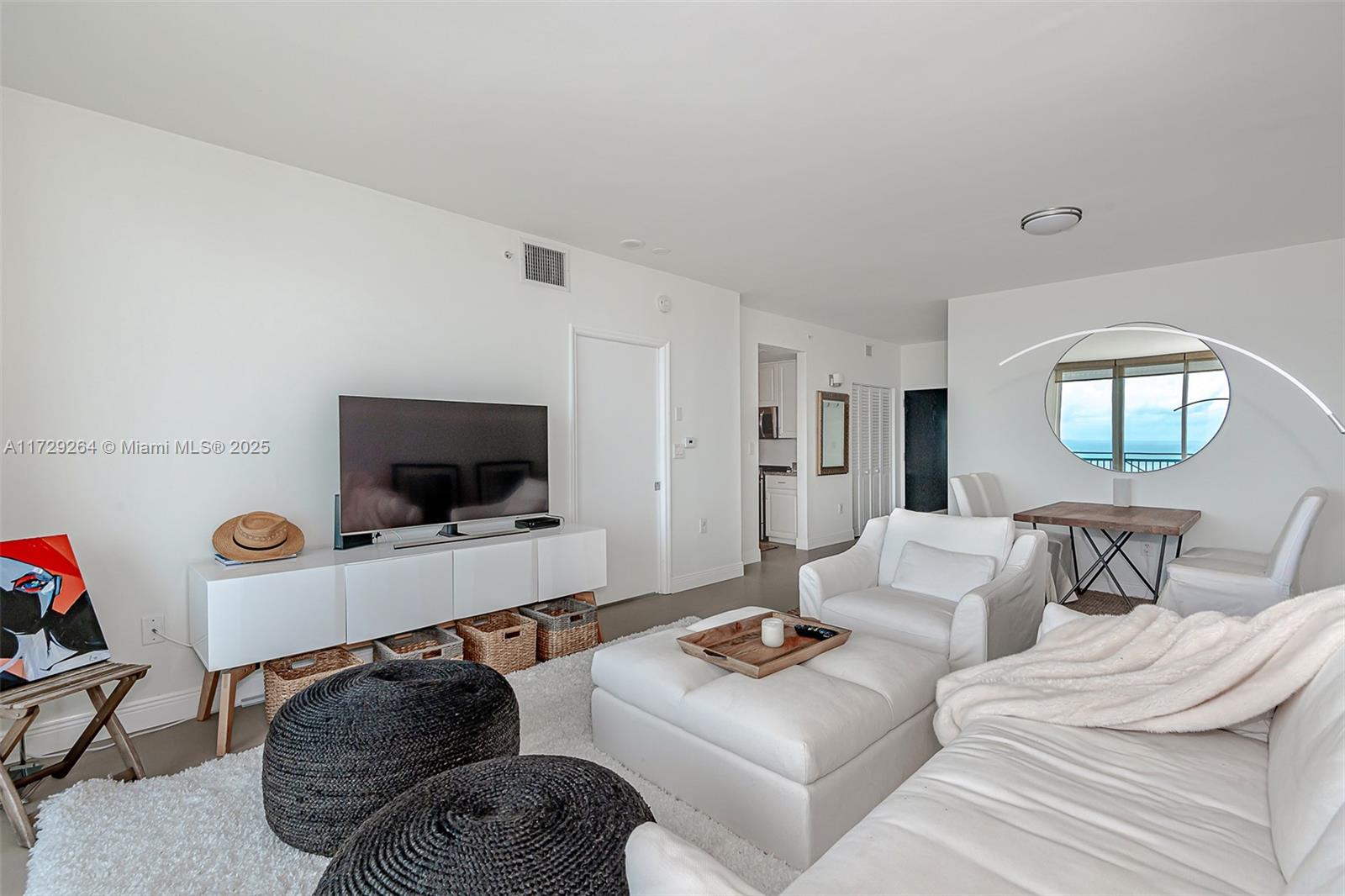 90 Alton Road, Unit PH3205 Miami Beach, FL 33139 - Photo 11 of 28 a living room with furniture and a flat screen tv