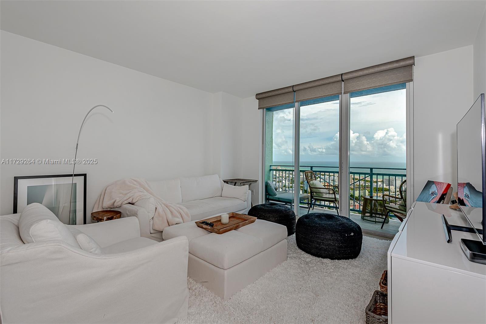 90 Alton Road, Unit PH3205 Miami Beach, FL 33139 - Photo 12 of 28 a bed room with a bed and a large window