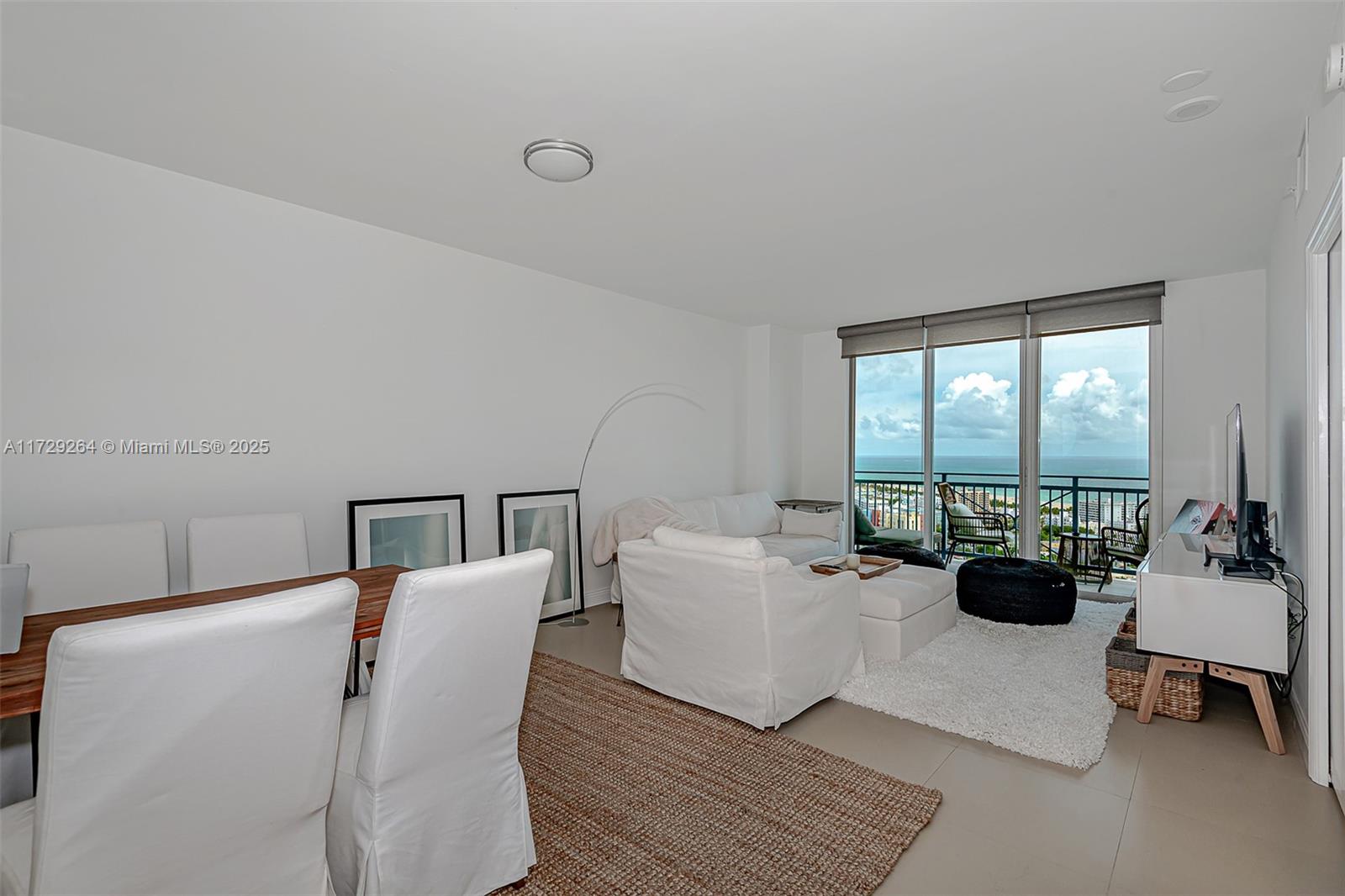 90 Alton Road, Unit PH3205 Miami Beach, FL 33139 - Photo 13 of 28 a living room with furniture and floor to ceiling window