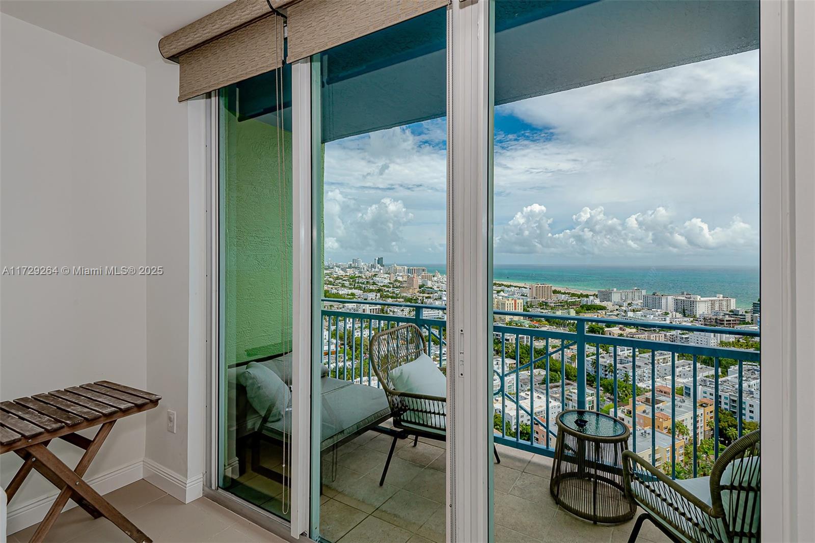 90 Alton Road, Unit PH3205 Miami Beach, FL 33139 - Photo 14 of 28 a view of a balcony with chair and floor to ceiling window