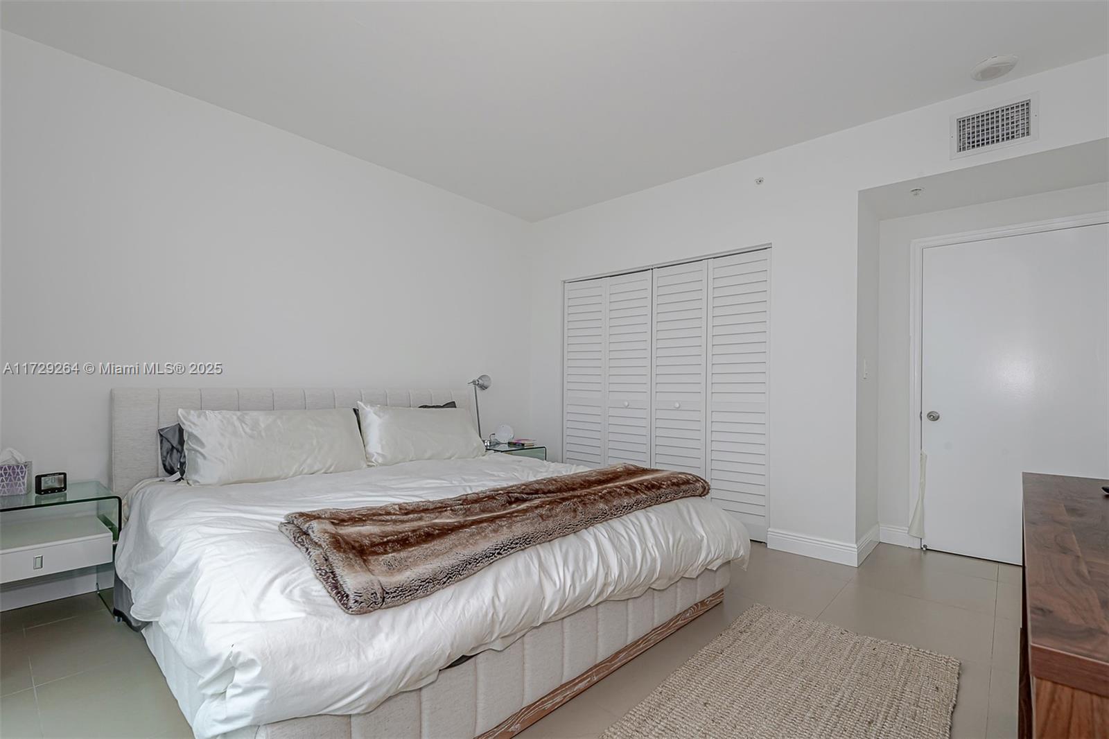 90 Alton Road, Unit PH3205 Miami Beach, FL 33139 - Photo 16 of 28 a bedroom with a bed and a couch