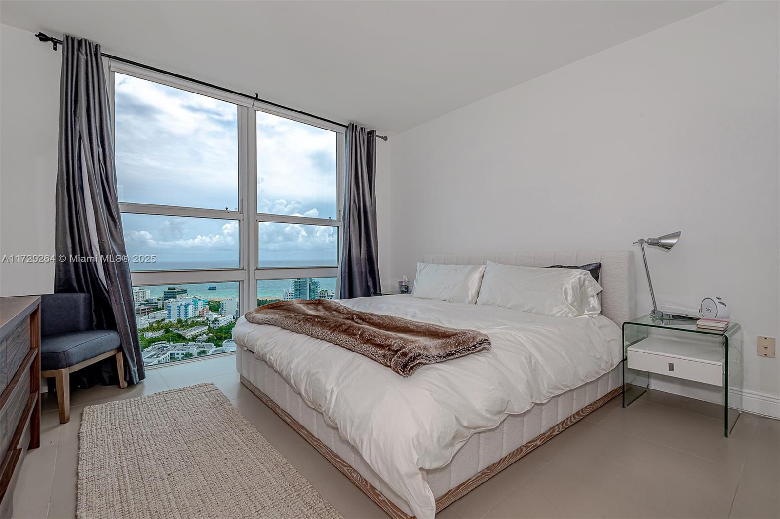 90 Alton Road, Unit PH3205 Miami Beach, FL 33139 - Photo 17 of 28 a bedroom with a bed and a window