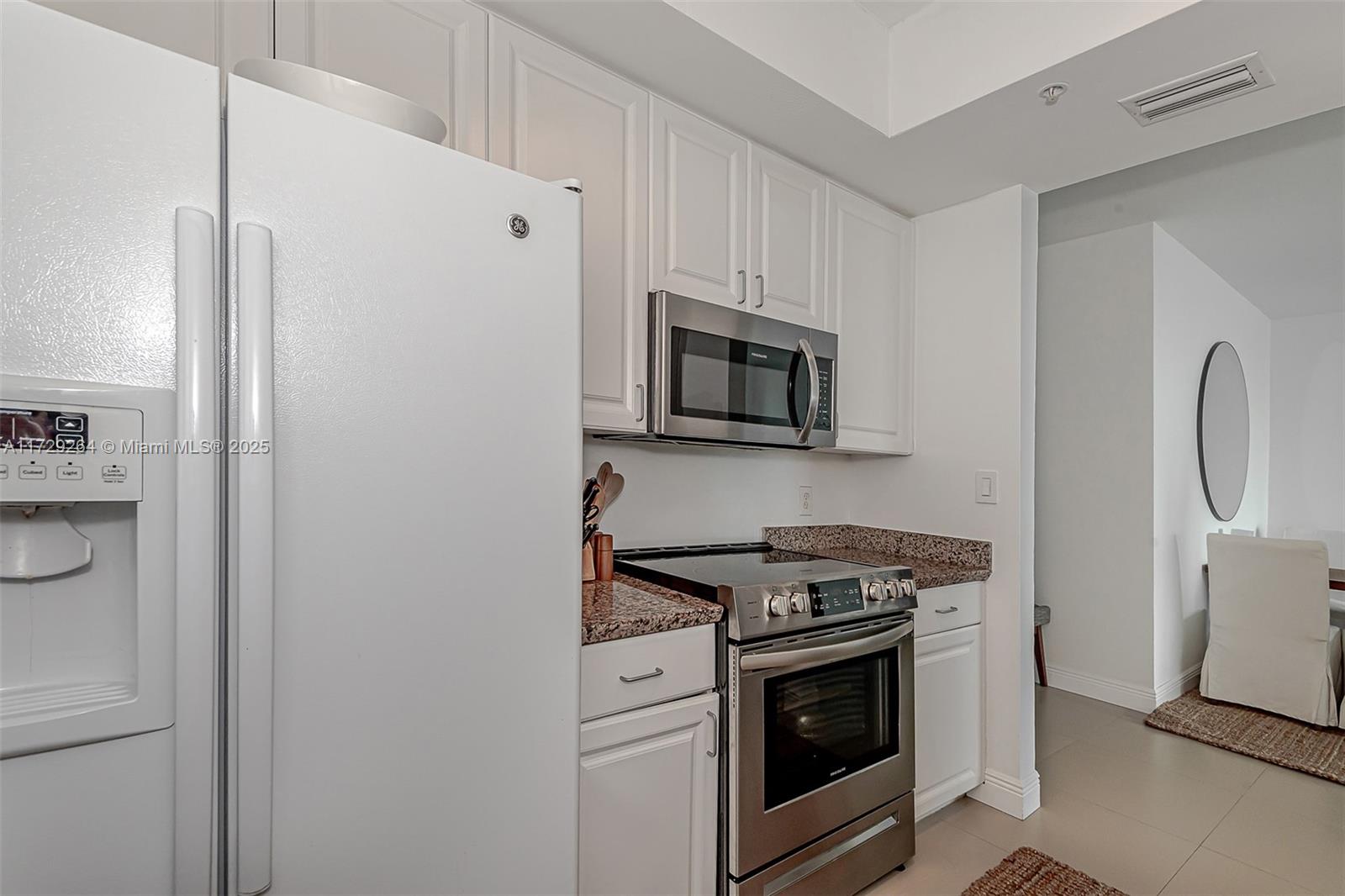 90 Alton Road, Unit PH3205 Miami Beach, FL 33139 - Photo 21 of 28 a kitchen with stainless steel appliances white cabinets and a stove