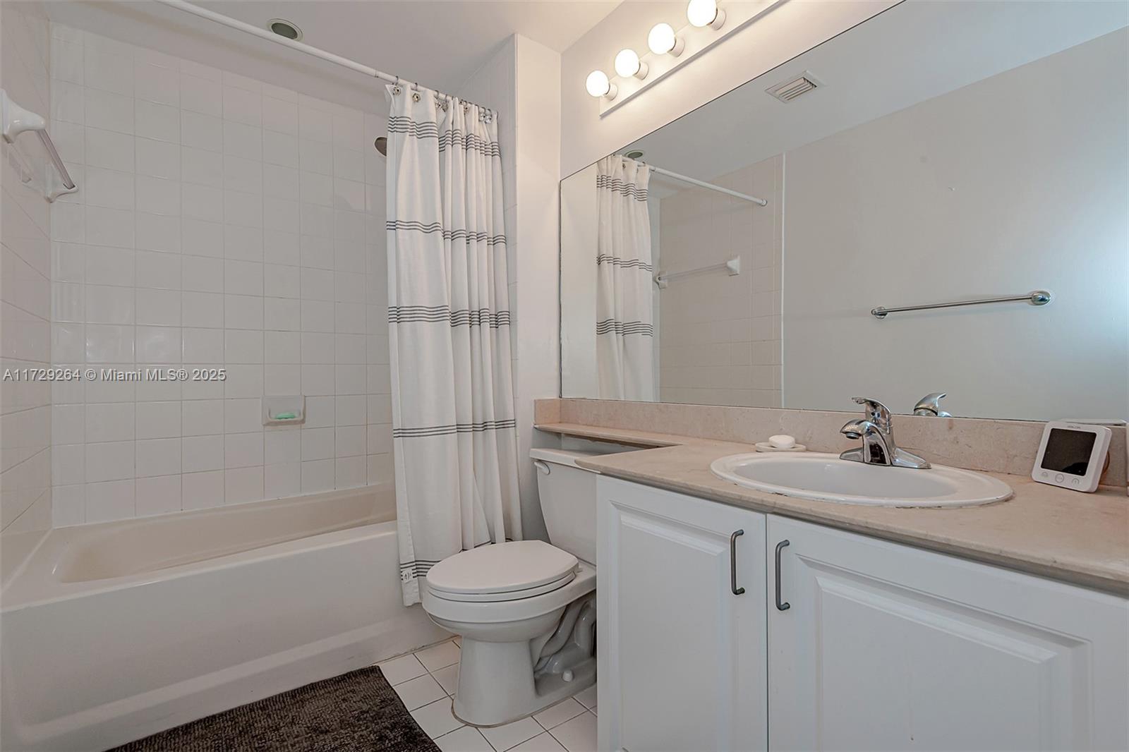 90 Alton Road, Unit PH3205 Miami Beach, FL 33139 - Photo 24 of 28 a bathroom with a sink toilet vanity and shower