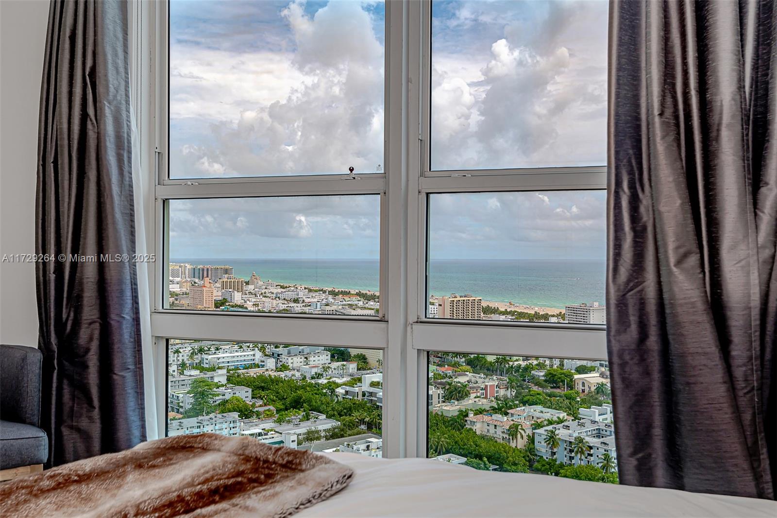 90 Alton Road, Unit PH3205 Miami Beach, FL 33139 - Photo 25 of 28 a view of a glass door with a tree in front of it