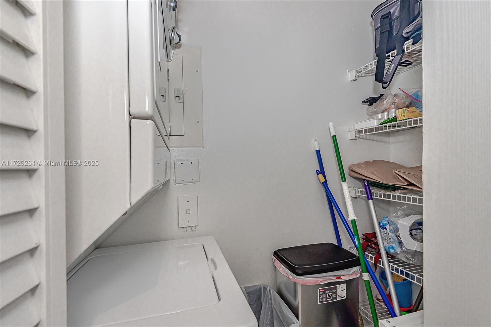 90 Alton Road, Unit PH3205 Miami Beach, FL 33139 - Photo 26 of 28 a view of walk in closet with clothes and shoes