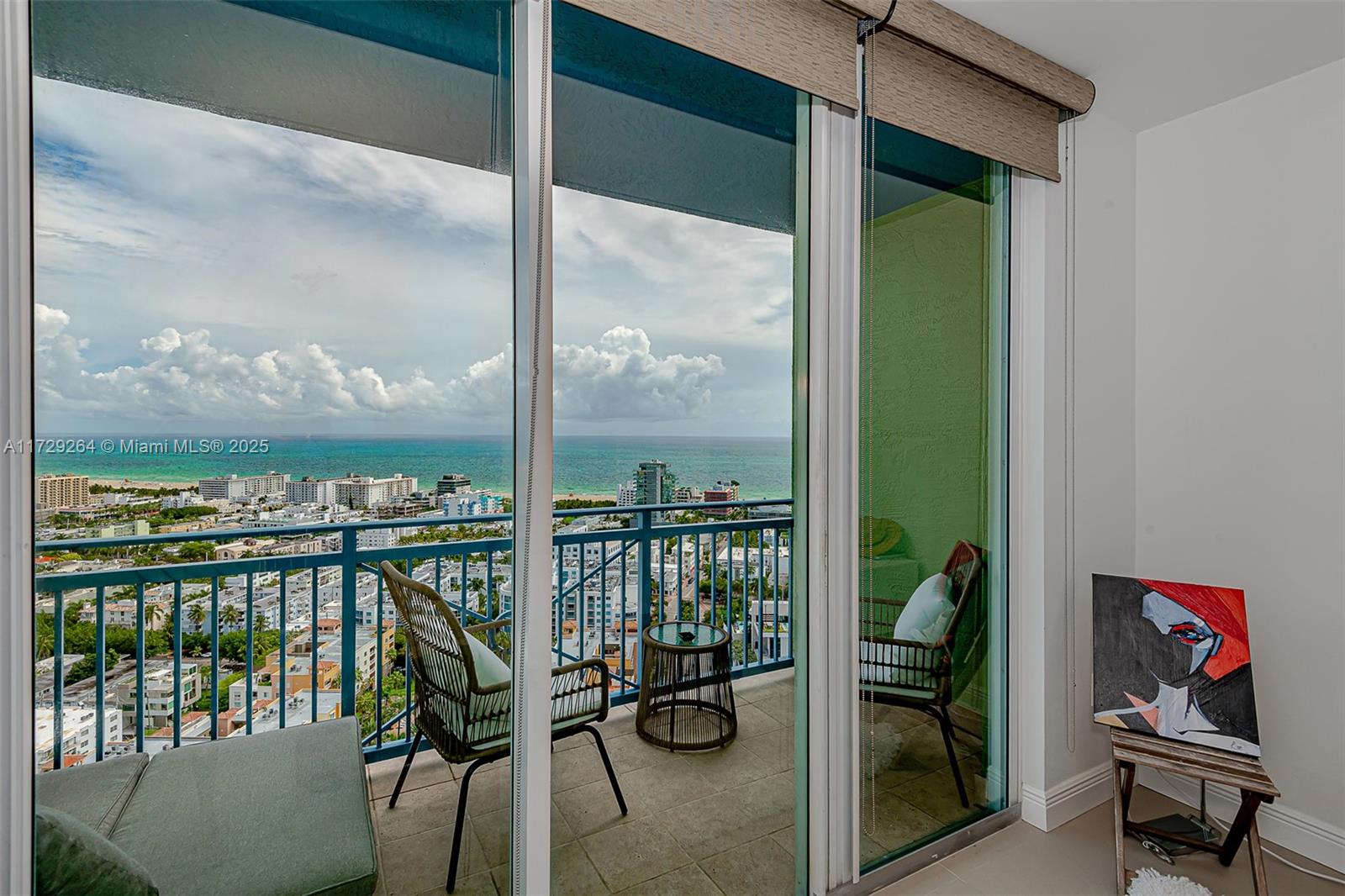 90 Alton Road, Unit PH3205 Miami Beach, FL 33139 - Photo 3 of 28 a view of a balcony with chairs and a potted plant