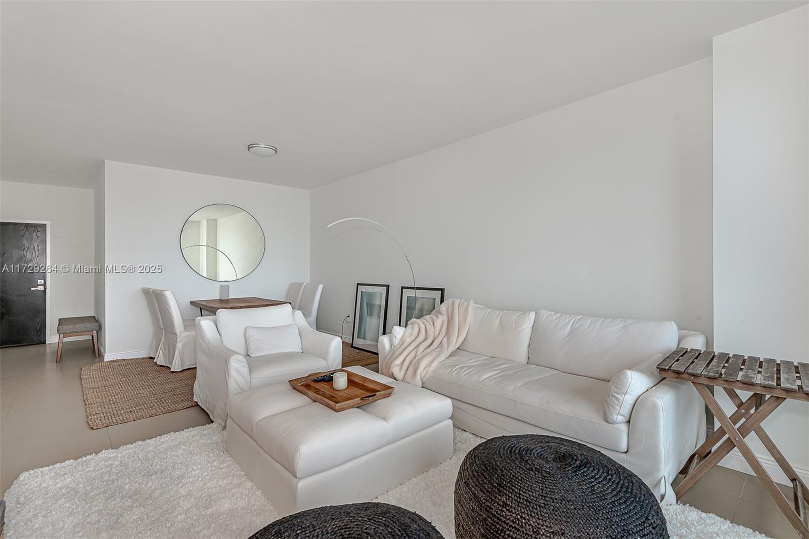 90 Alton Road, Unit PH3205 Miami Beach, FL 33139 - Photo 7 of 28 a living room with furniture a rug and a window