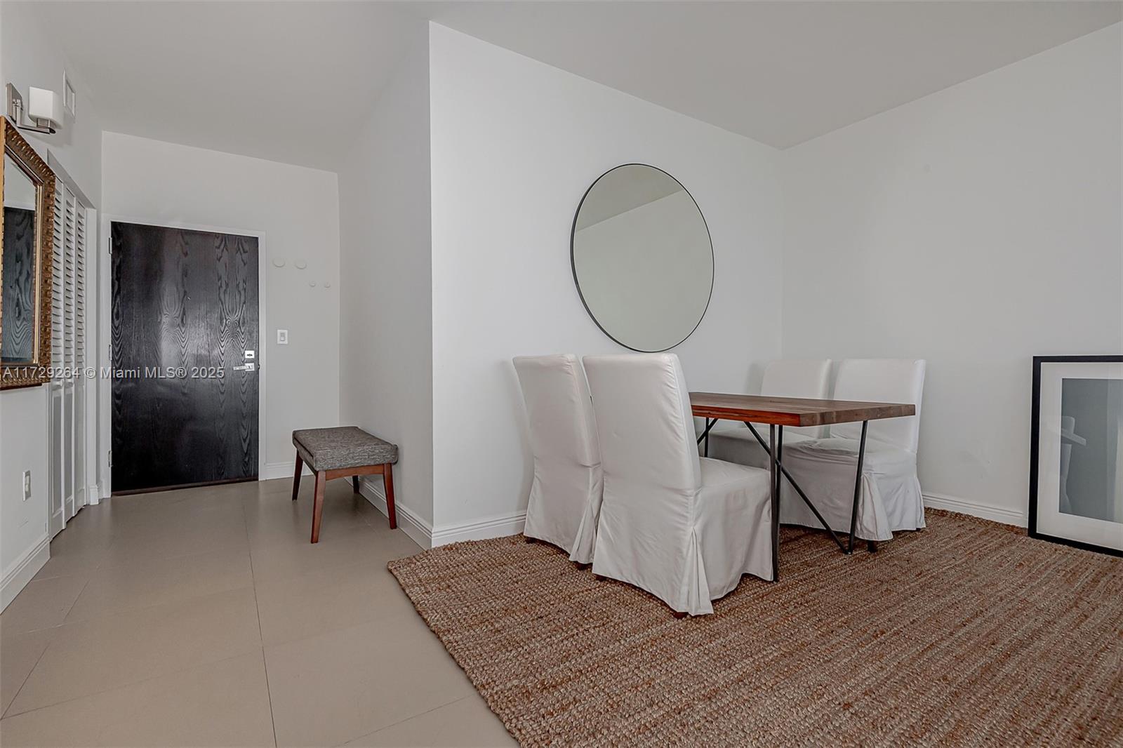 90 Alton Road, Unit PH3205 Miami Beach, FL 33139 - Photo 10 of 28 a view of a livingroom with furniture and wooden floor