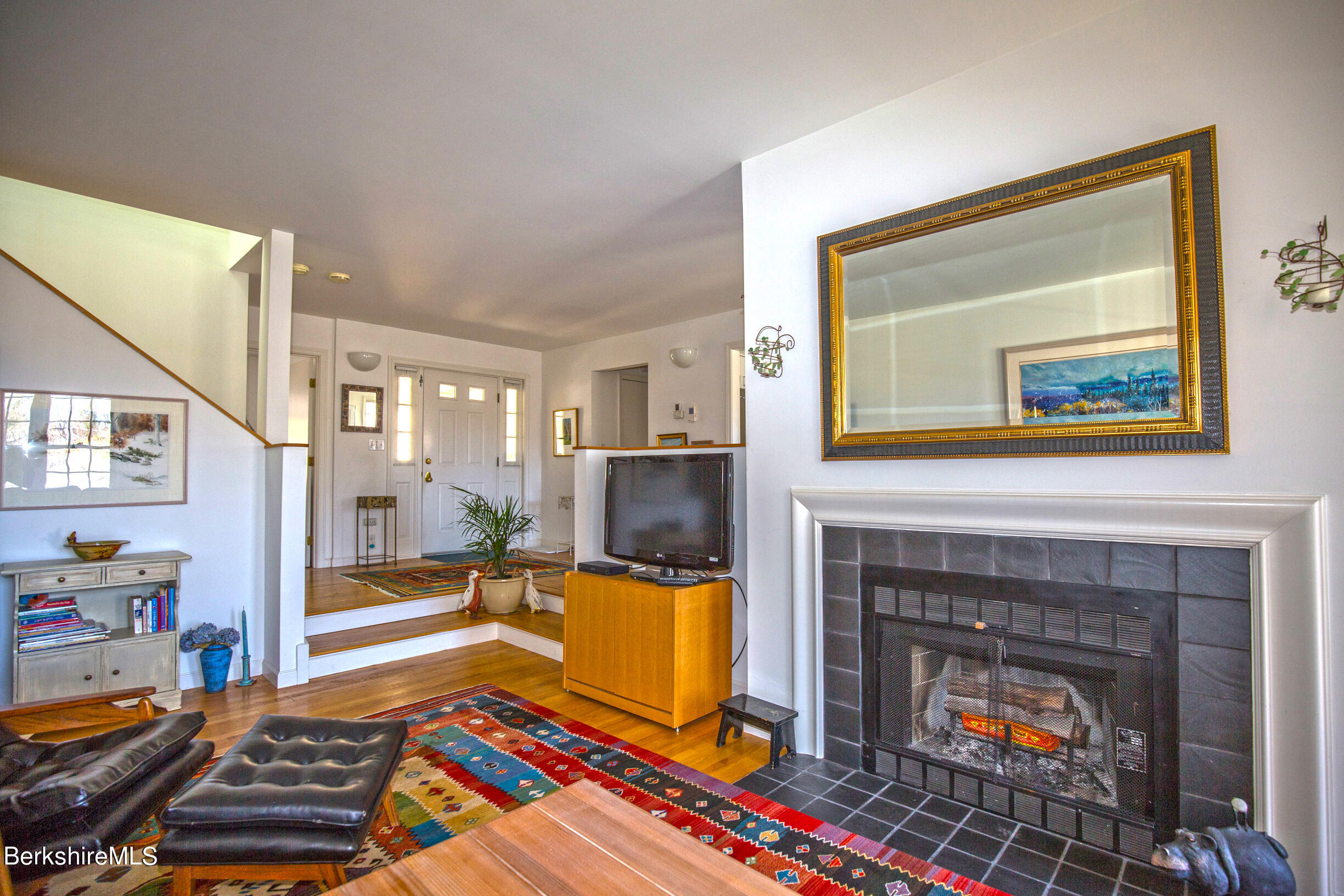 1136 Barker Road, Unit 48 Pittsfield, MA 01201 - Photo 1 of 53 a living room with furniture and a fireplace