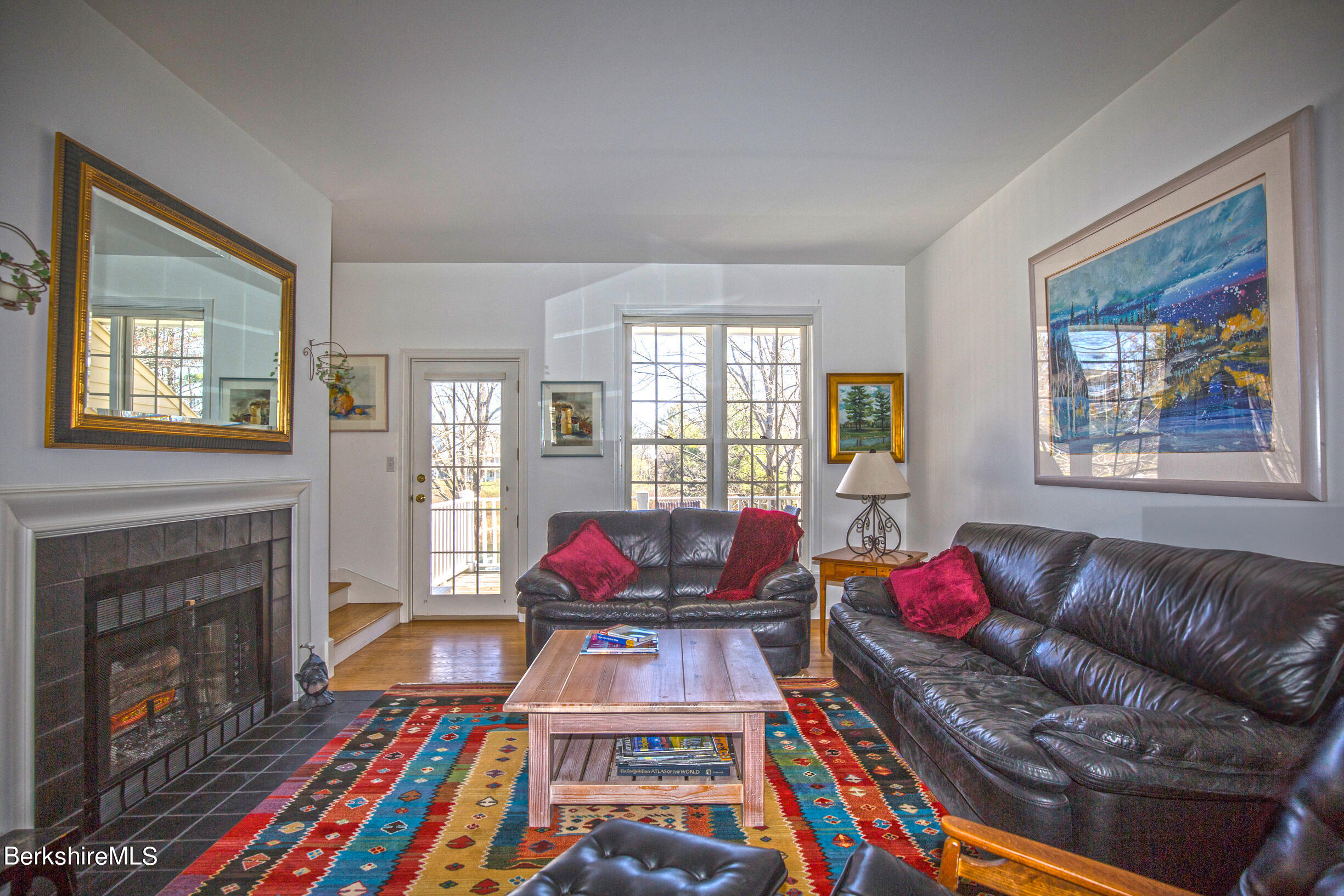 1136 Barker Road, Unit 48 Pittsfield, MA 01201 - Photo 20 of 53 a living room with furniture a flat screen tv and a fireplace