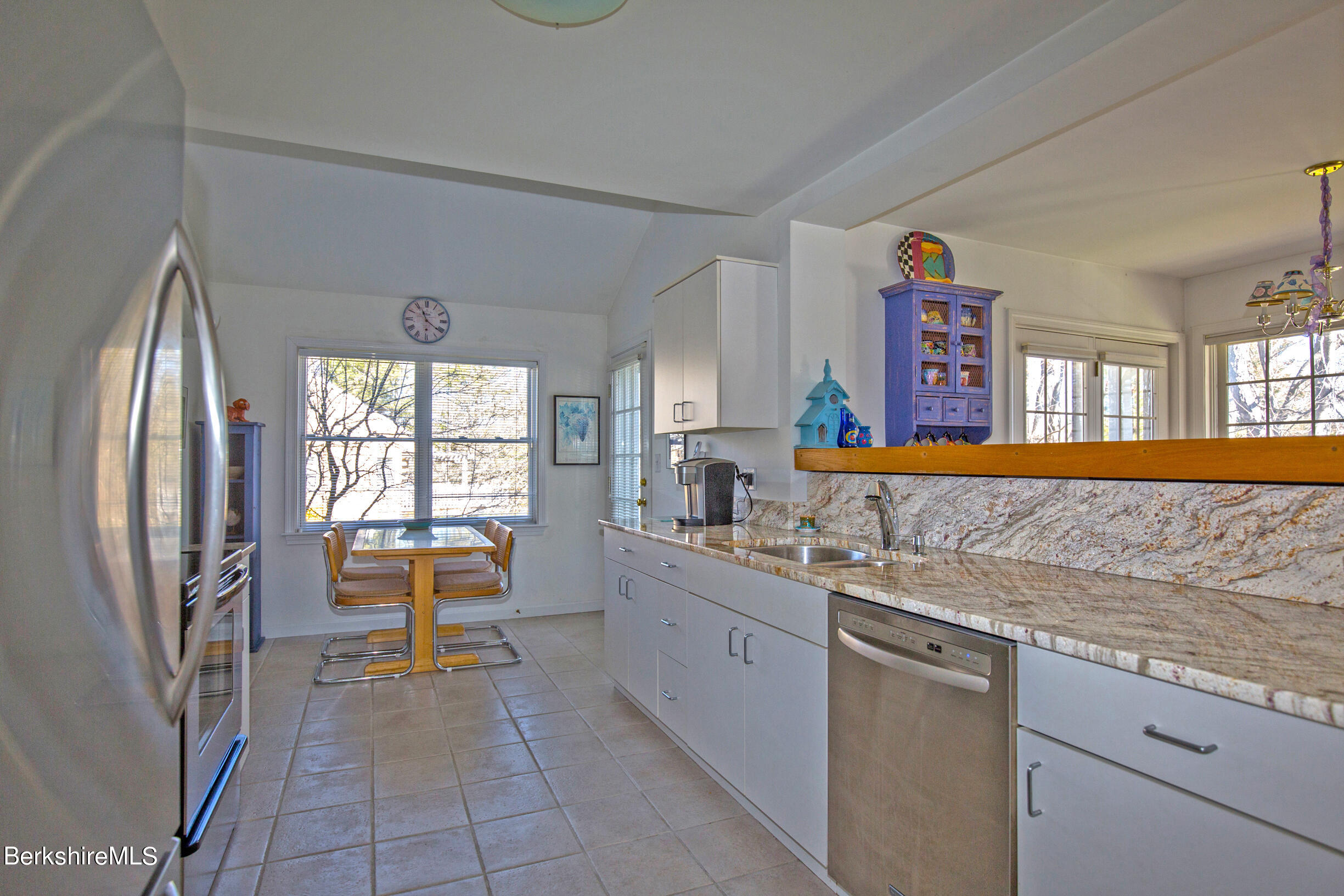 1136 Barker Road, Unit 48 Pittsfield, MA 01201 - Photo 27 of 53 a kitchen with stainless steel appliances granite countertop a sink stove and refrigerator