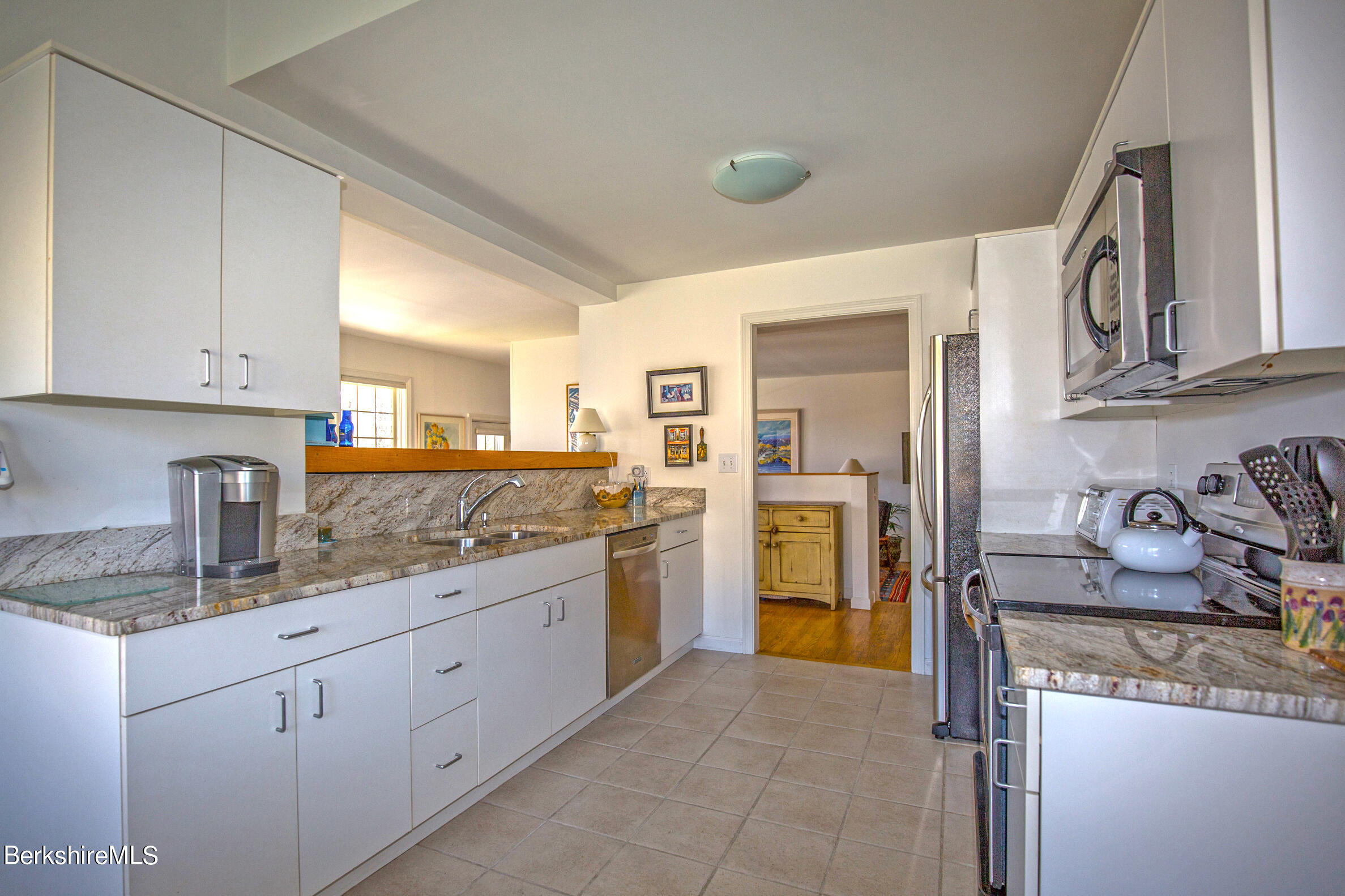 1136 Barker Road, Unit 48 Pittsfield, MA 01201 - Photo 28 of 53 a kitchen with stainless steel appliances granite countertop a sink and cabinets