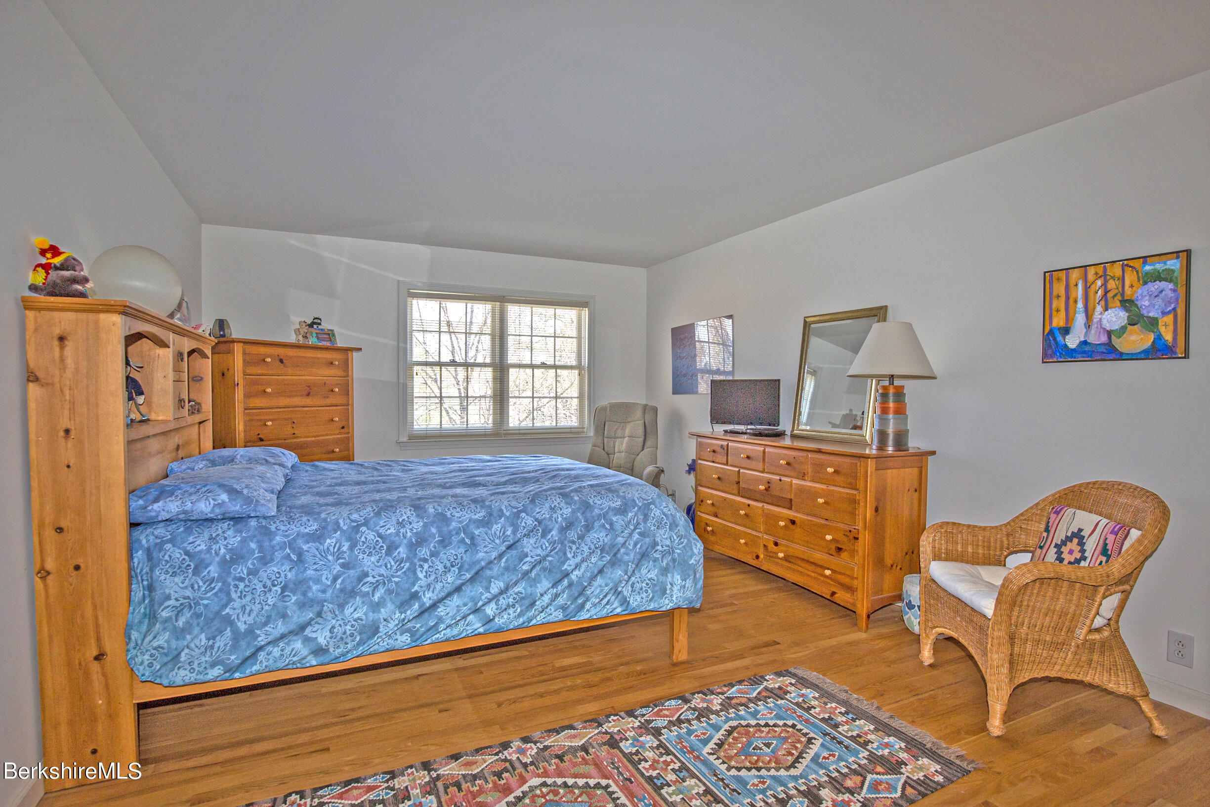 1136 Barker Road, Unit 48 Pittsfield, MA 01201 - Photo 34 of 53 a bedroom with a bed and wooden floor