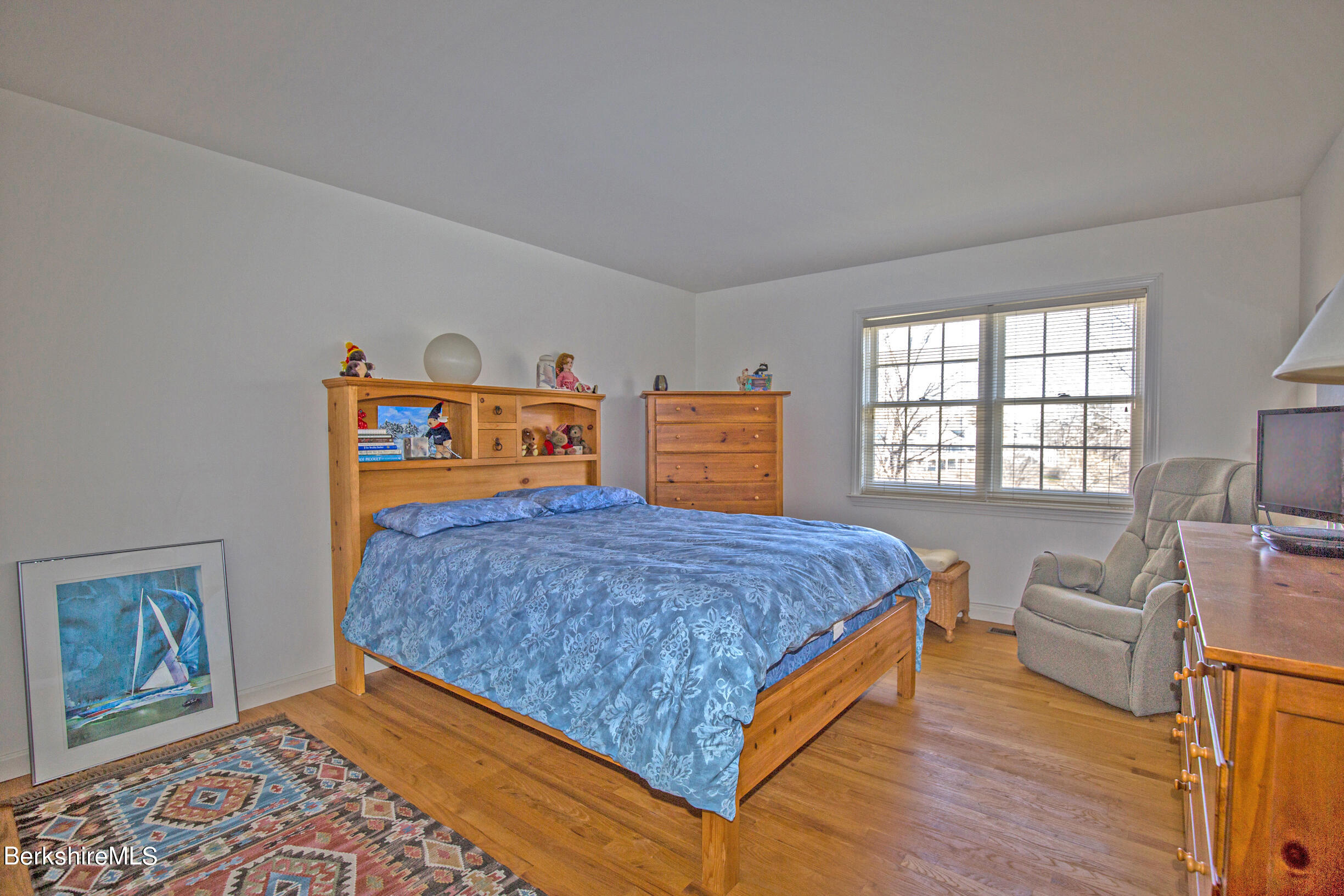 1136 Barker Road, Unit 48 Pittsfield, MA 01201 - Photo 35 of 53 a bedroom with a bed and wooden floor